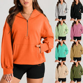 Woman wearing oversized zip-up hoodie in multiple colors, casual streetwear style, loose fit.
