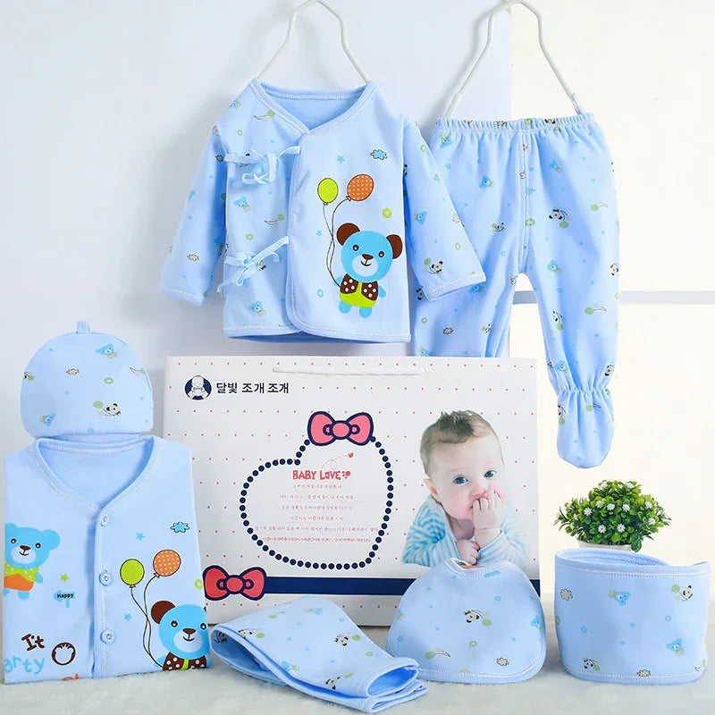 Light blue baby clothing set with cartoon bear print, soft cotton, long sleeve top, pants, hat, and mittens.