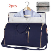 Navy blue duffel garment bag with gold zippers, hanger slot, and matching accessory pouch