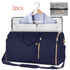 Navy blue duffel garment bag with gold zippers, hanger slot, and matching accessory pouch