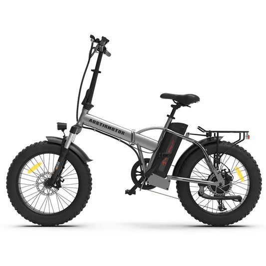 Silver folding electric bike with fat tires, front suspension, and rear cargo rack, side view