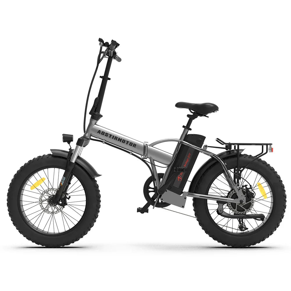 Silver folding electric bike with fat tires, black accents, rear rack, and upright handlebars