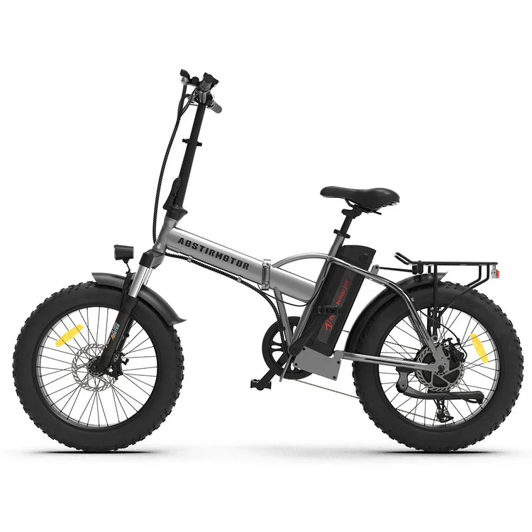 Silver folding electric bike with fat tires, black accents, rear rack, and upright handlebars