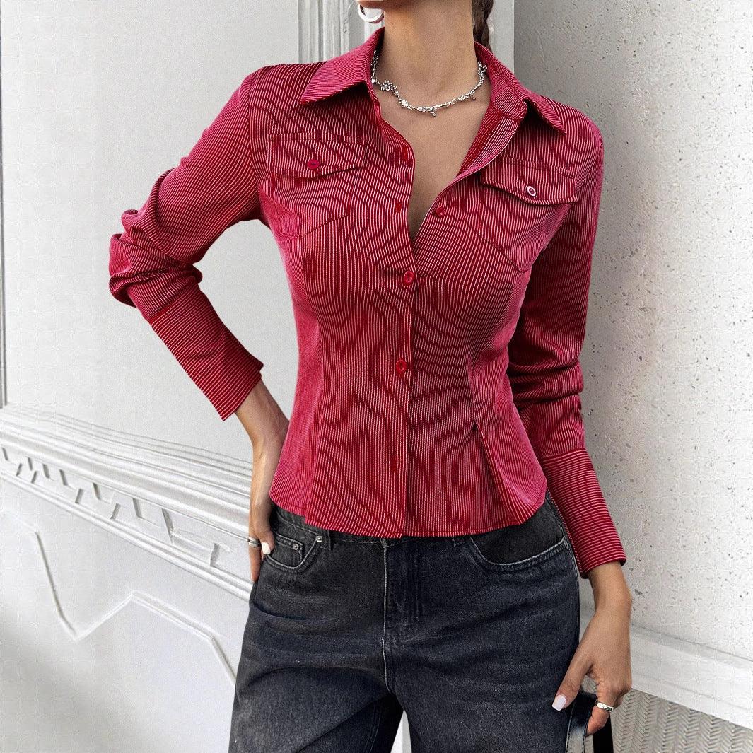Woman wearing fitted red pinstripe button-up shirt with long sleeves and dark denim jeans