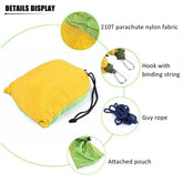 Yellow and green nylon parachute hammock with attached pouch, hooks, and guy rope.