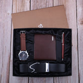 Gift set with brown leather watch, textured brown wallet, red pen, and black leather belt