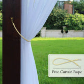 Outdoor white sheer curtain with free yellow tieback rope, draped on wooden post