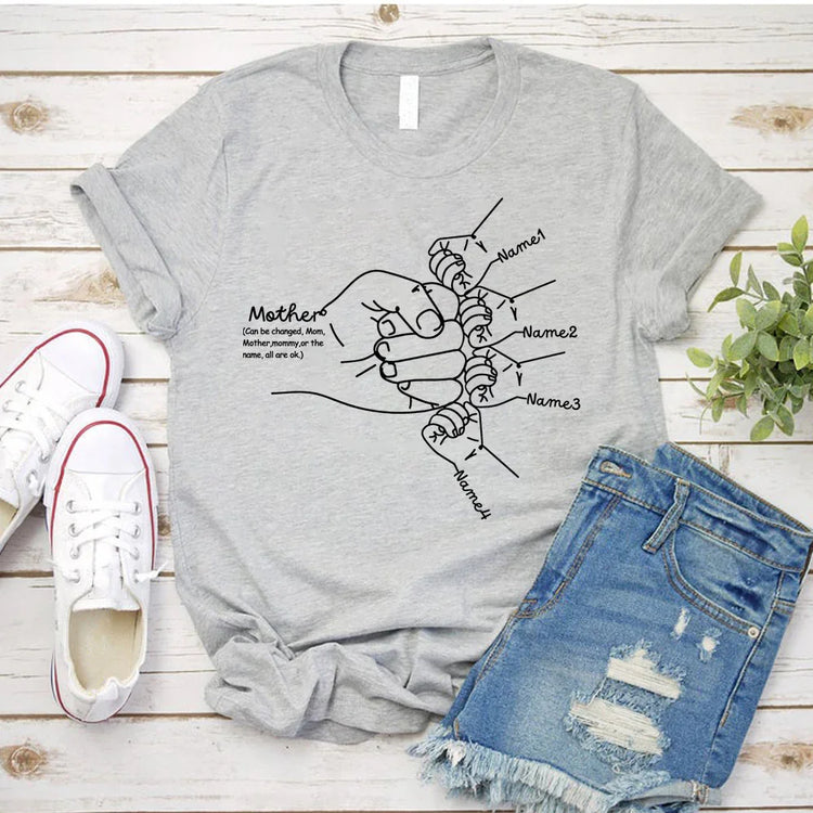 Light gray cotton graphic tee with rolled sleeves, featuring a hand-drawn family line art design, paired with distressed denim shorts, casual streetwear style.