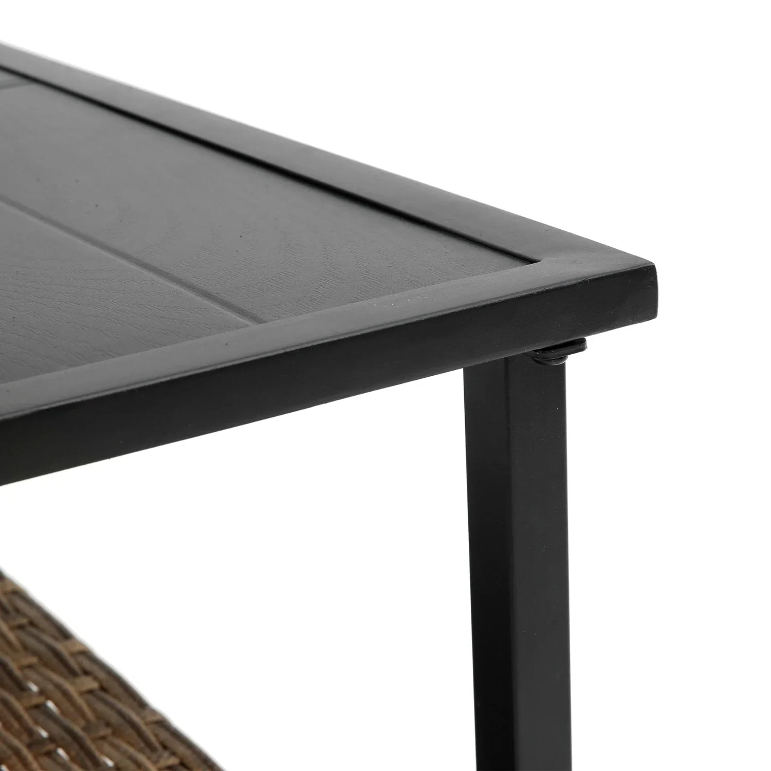 Close-up of modern black metal and wood table corner with woven detail underneath