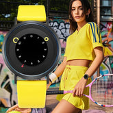 Woman in yellow cropped athletic top and shorts set with blue stripes, wearing yellow wristwatch, holding tennis racket, urban graffiti background.