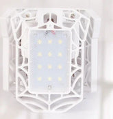 White tech accessory with geometric cage design and LED lights, futuristic style.