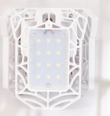White tech accessory with geometric cage design and LED lights, futuristic style.