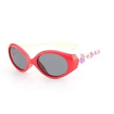 Red oval sunglasses with black lenses and white arms, playful streetwear accessory