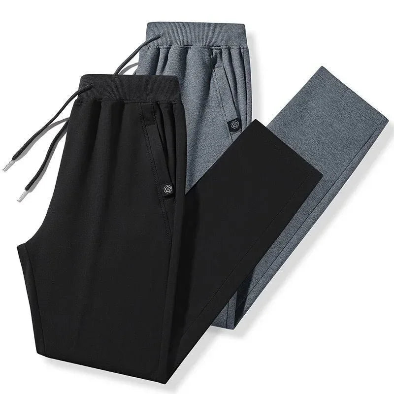 Black and gray slim fit jogger pants with drawstring waist, soft material, modern streetwear style