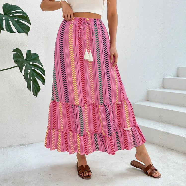 Woman wearing a pink boho maxi skirt with chevron stripes, lightweight fabric, relaxed fit