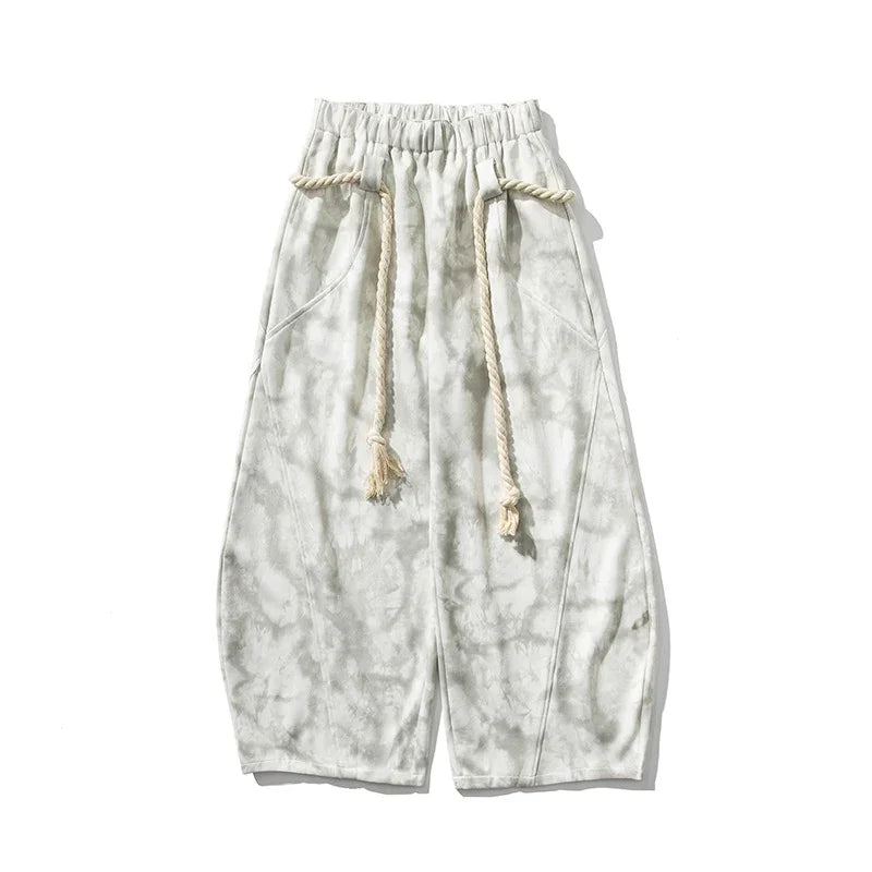 Wide-leg tie-dye pants in light gray with drawstring waist and relaxed fit streetwear style