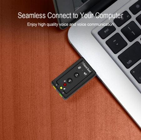 Compact black USB audio adapter with LED indicators plugged into a silver laptop