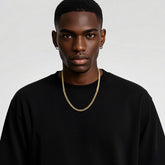 14K gold Cuban link chain necklace on man wearing black shirt, trendy chunky gold chain jewelry for men and women