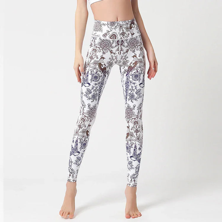 Woman wearing white high-waisted leggings with blue and brown floral print, slim fit.