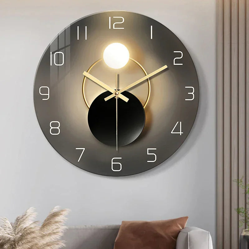 Modern wall clock with black and gold circular design, large white numerals, sleek finish