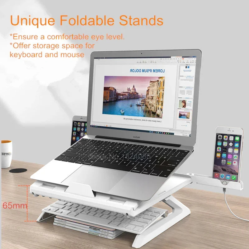 White foldable laptop stand on desk with silver laptop, keyboard, and phone holder
