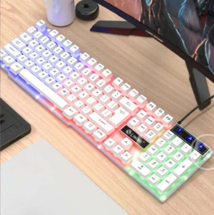 White mechanical RGB gaming keyboard with backlit keys on a wooden desk setup