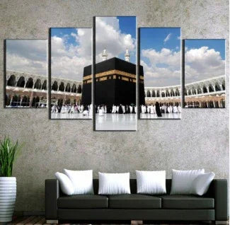 Modern living room with wall art depicting the Kaaba, neutral sofa, and white accent pillows