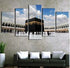 Modern wall art of Kaaba above a dark sofa with white cushions in contemporary living room