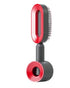 Red and black futuristic hair styling brush with sleek plastic finish and built-in dryer