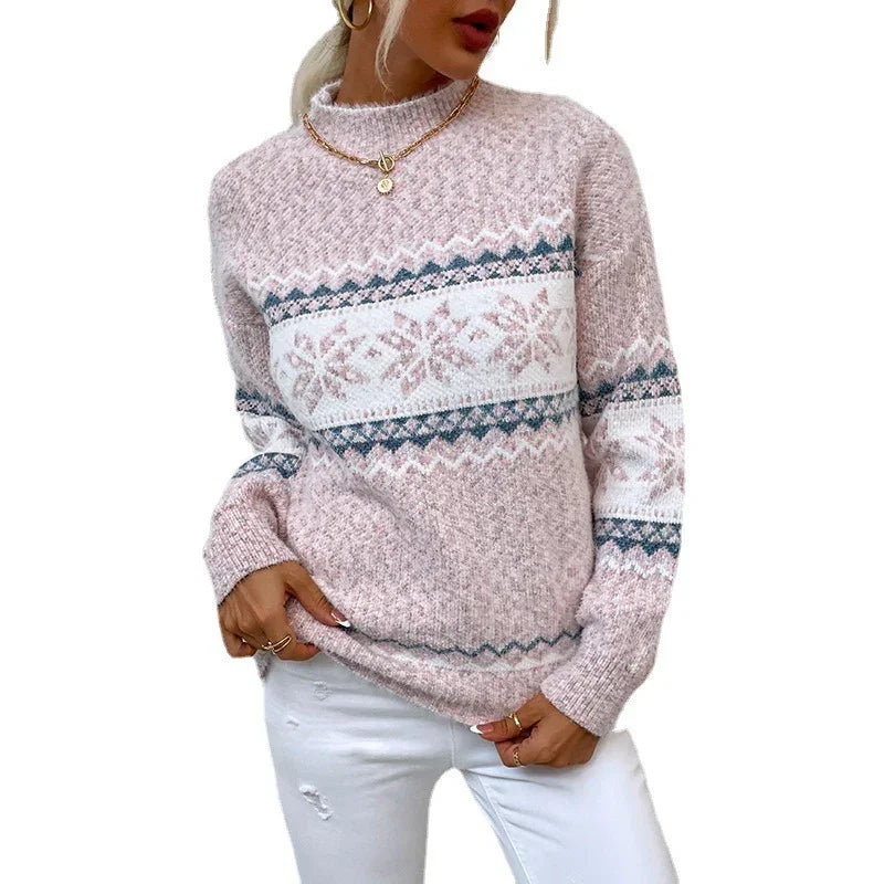 Woman wearing a pink knitted sweater with Nordic snowflake pattern and relaxed fit