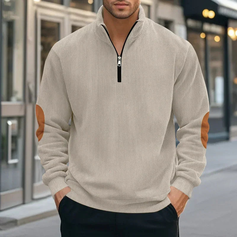 Beige ribbed quarter-zip pullover with brown suede elbow patches, relaxed fit streetwear style.