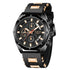 Black and gold chronograph watch with silicone strap, bold face, and metallic accents