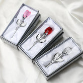 Crystal rose brooches with silver stems in gift boxes, featuring red, pink, and clear colors.