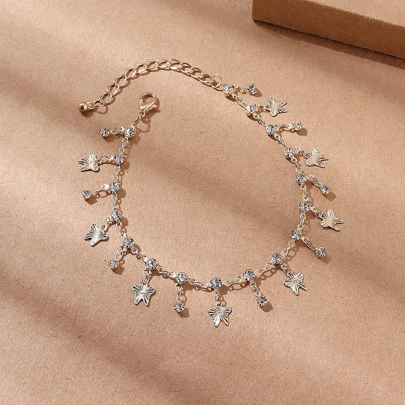 Gold chain bracelet with butterfly charms and crystal accents, delicate and adjustable fit