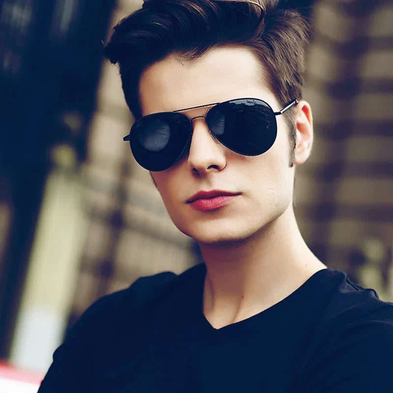 Man wearing black sunglasses and a fitted black crew neck t-shirt, modern streetwear style