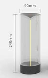 Modern cylindrical LED lamp with transparent body, black base, 240mm height, 90mm diameter.