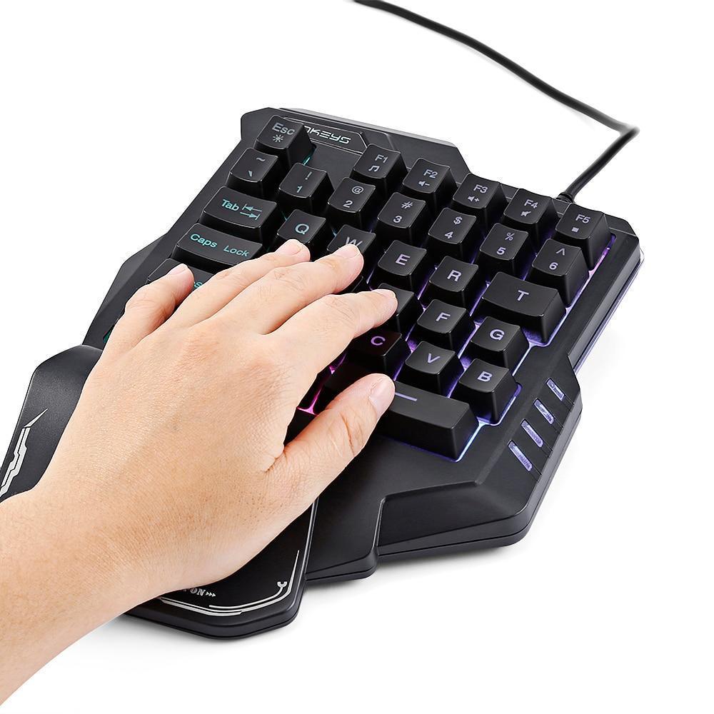 Hand on black one-handed RGB gaming keypad with ergonomic wrist rest