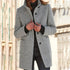 Woman wearing a light gray wool coat with button closure and relaxed fit over a black sweater