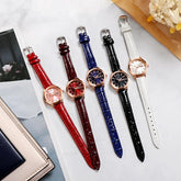 Assorted leather strap watches in red, brown, blue, black, and white with rose gold cases