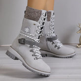 Light gray lace-up winter boots with chunky sole, knit cuffs, and side buckle detail