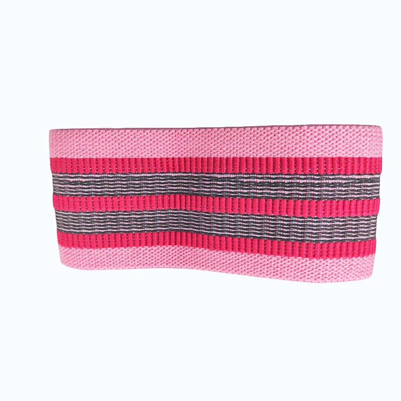 Wide pink and black striped knit headband with ribbed texture and stretchy fabric.