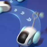 Futuristic toy robot with blue wheels moving on a blue surface, sleek modern design.