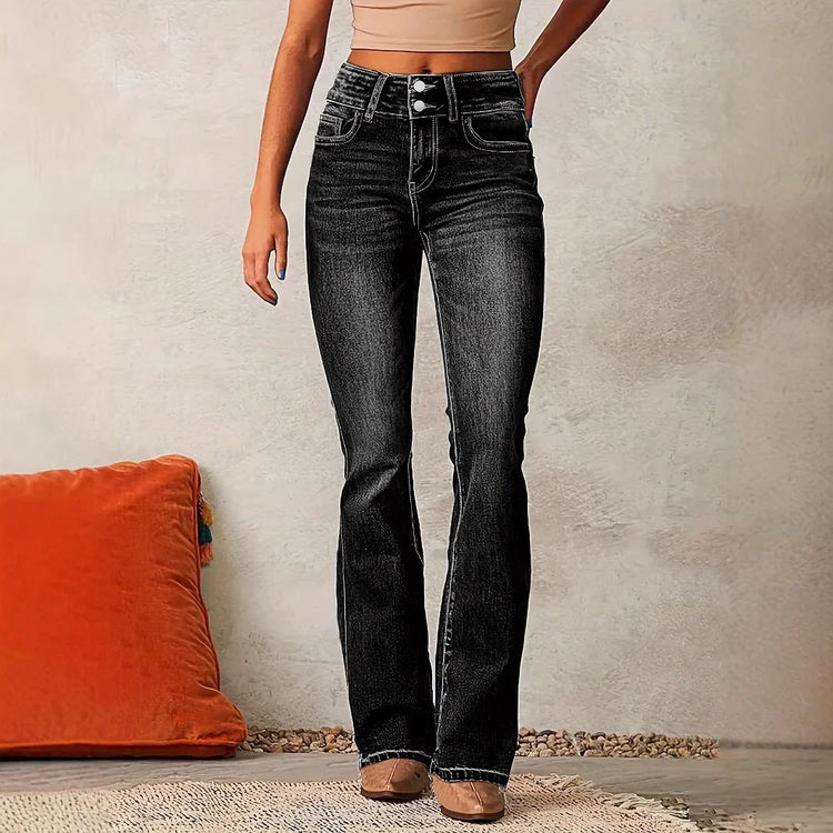Woman wearing high-waisted black flare jeans with contrast stitching, slim fit leg