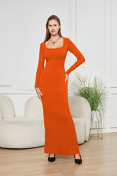 Woman wearing a fitted orange long-sleeve knit maxi dress with square neckline