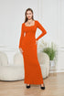 Woman wearing a fitted orange long-sleeve knit maxi dress with square neckline