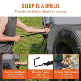 Man in sleeveless dark tank top adjusting black strap on outdoor tent attached to car, easy installation