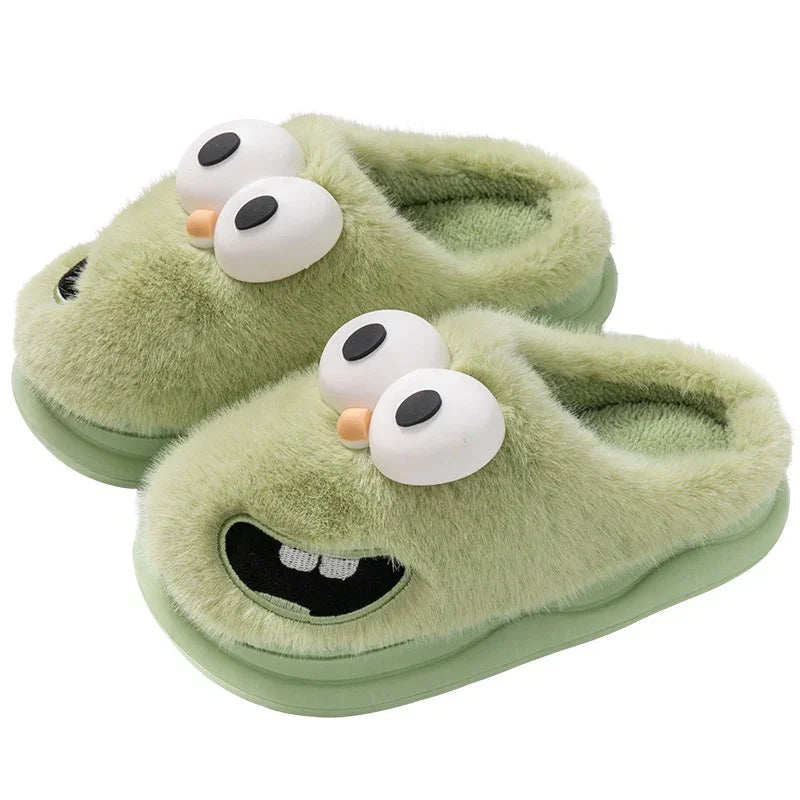 Green fuzzy slippers with cartoon eyes and teeth, cozy plush slip-on style