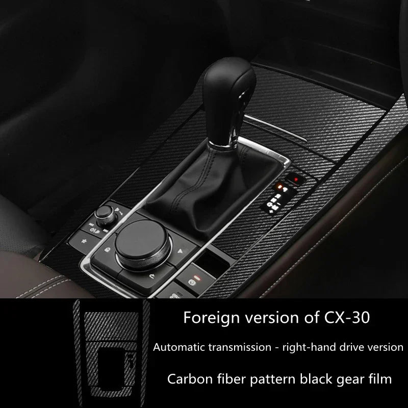 Carbon fiber pattern black gear shift cover for right-hand drive car, sleek modern interior.
