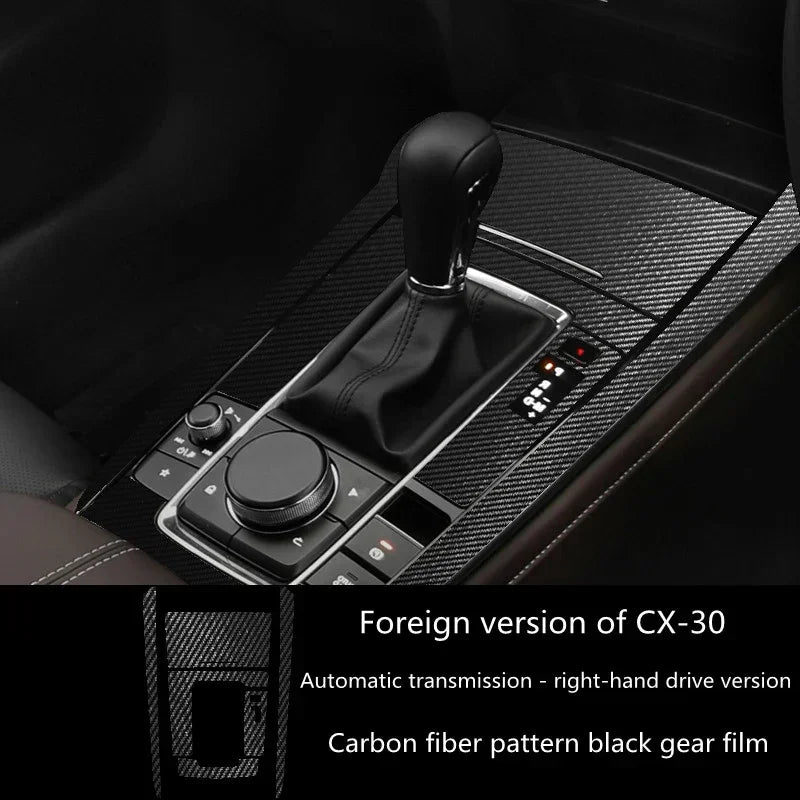 Carbon fiber pattern black gear shift cover for right-hand drive car, sleek modern interior.