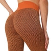Orange high-waisted leggings with black geometric pattern, stretchy fit, athletic wear style